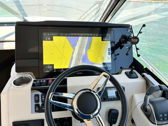  Yacht Photos Pics 2023 Regal Grande Coupe dashboard with navigation display and steering wheel.