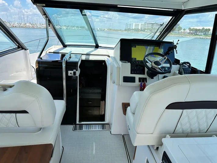  Yacht Photos Pics 2023 Regal Grande Coupe yacht interior with modern helm and luxurious seating.