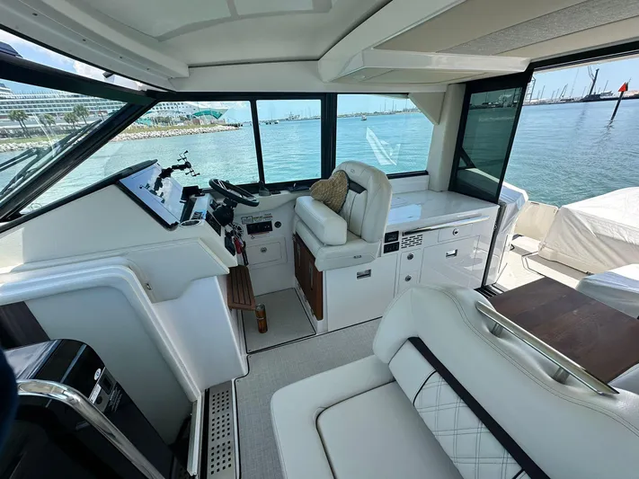  Yacht Photos Pics Luxurious interior of 2023 Regal Grande Coupe yacht with plush seating and scenic ocean view.