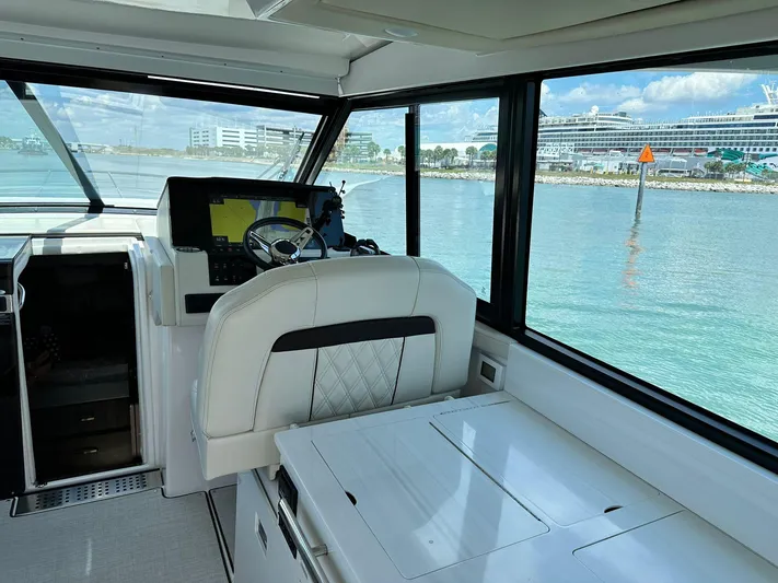  Yacht Photos Pics Interior of 2023 Regal Grande Coupe yacht with modern helm and waterfront view.