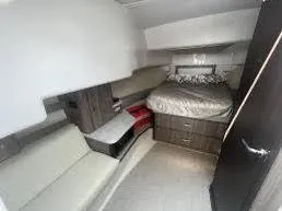  Yacht Photos Pics 2023 Regal Grande Coupe interior cabin with bed and seating area.