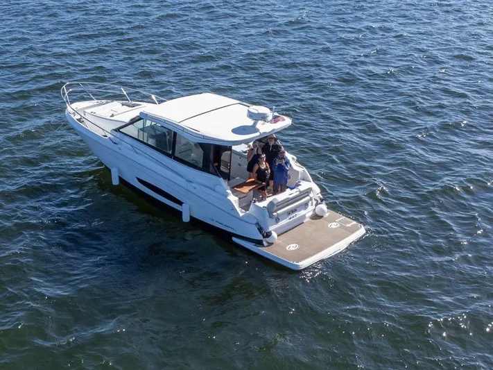  Yacht Photos Pics 2023 Regal Grande Coupe boat cruising on open water.