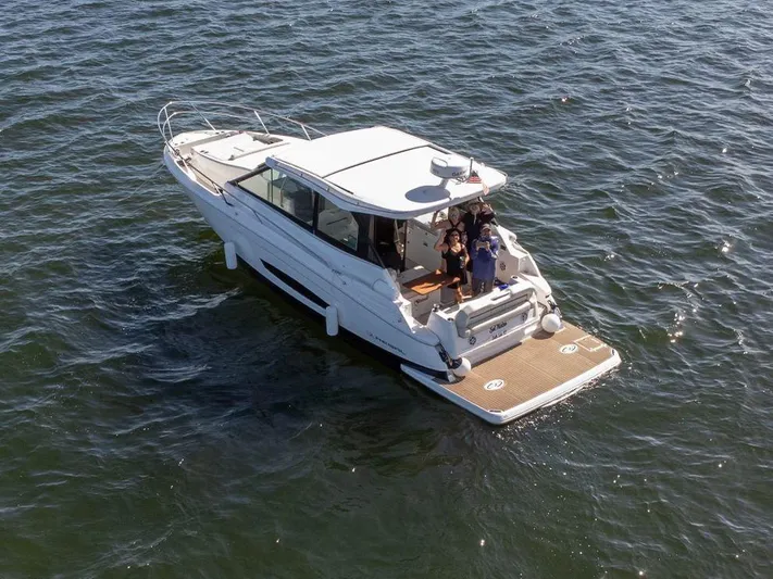  Yacht Photos Pics 2023 Regal Grande Coupe boat cruising on open water.