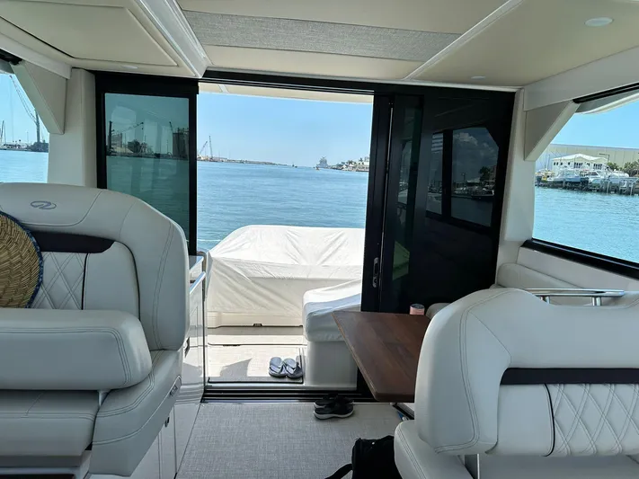 Yacht Photos Pics Interior view of 2023 Regal Grande Coupe yacht overlooking serene waterfront.