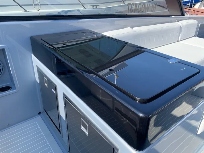  Yacht Photos Pics 2021 VanDutch 48 yacht interior with sleek black countertop and white seating.