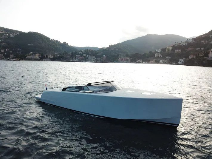  Yacht Photos Pics VanDutch 48 yacht from 2021 on serene water with scenic hillside backdrop.