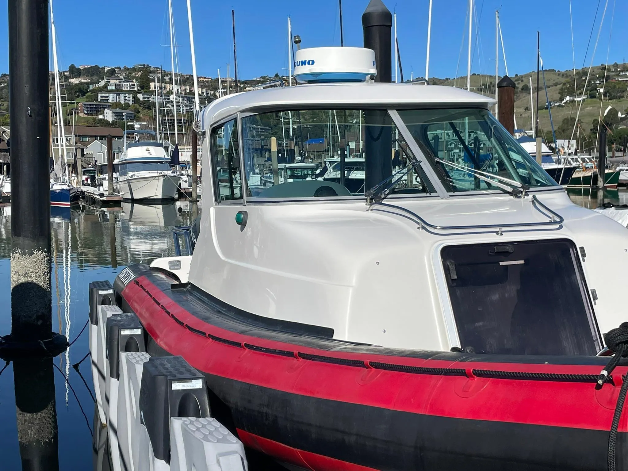 2001 Protector Targa 28 boat docked in a marina, surrounded by other vessels.