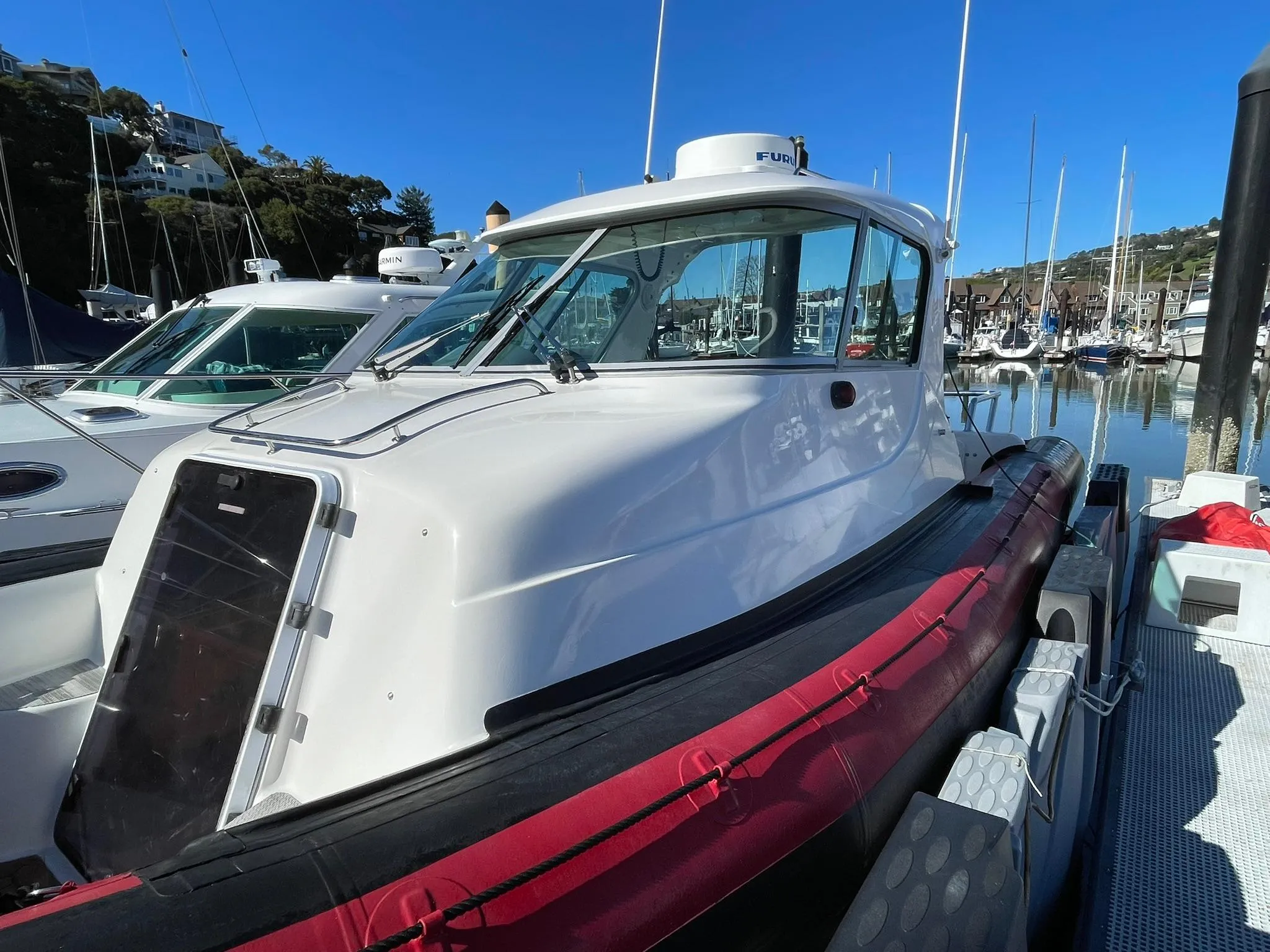 2001 Protector Targa 28 boat docked in a marina, surrounded by other vessels.