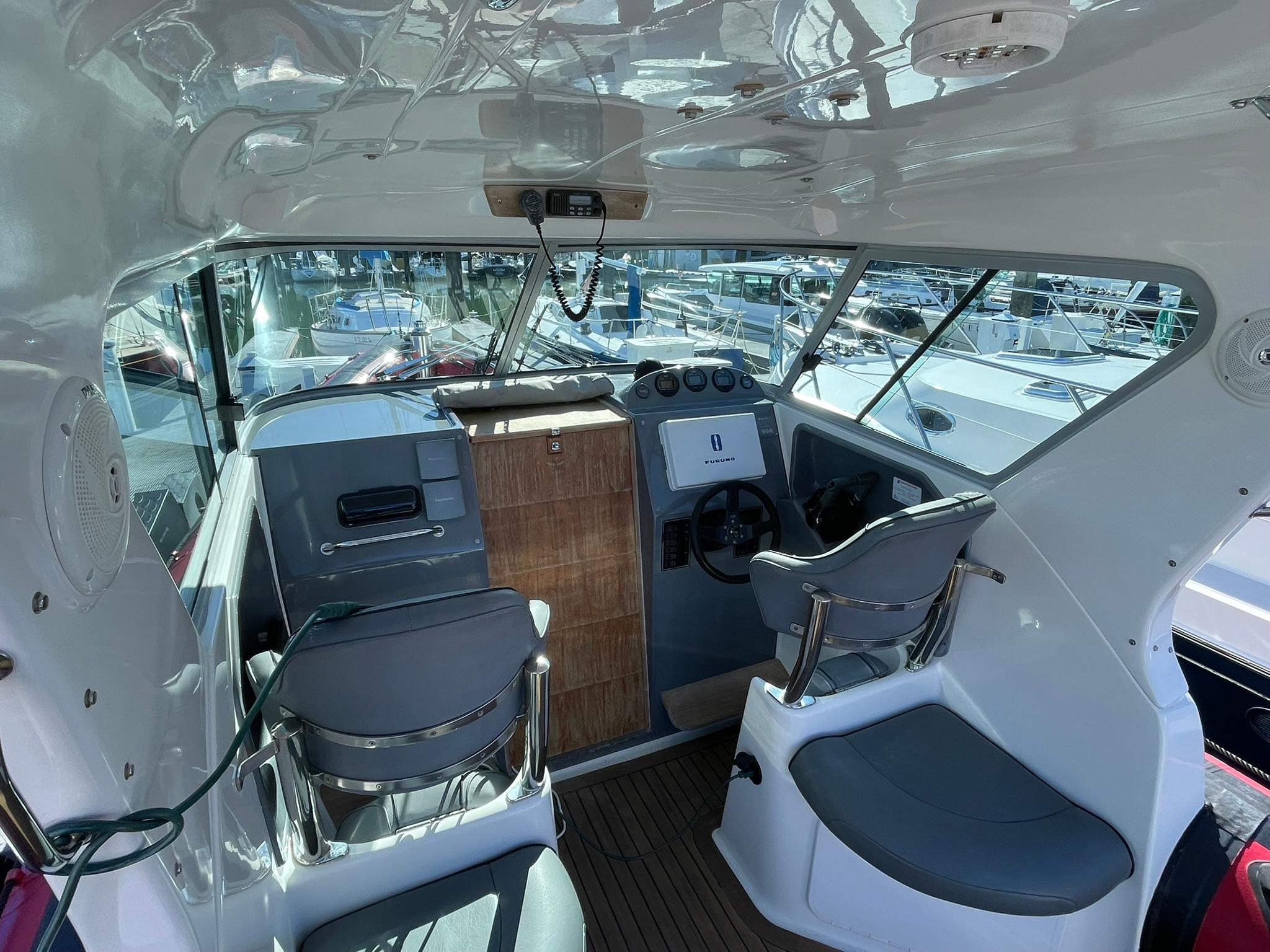Interior of 2001 Protector Targa 28 boat with helm and seating area.