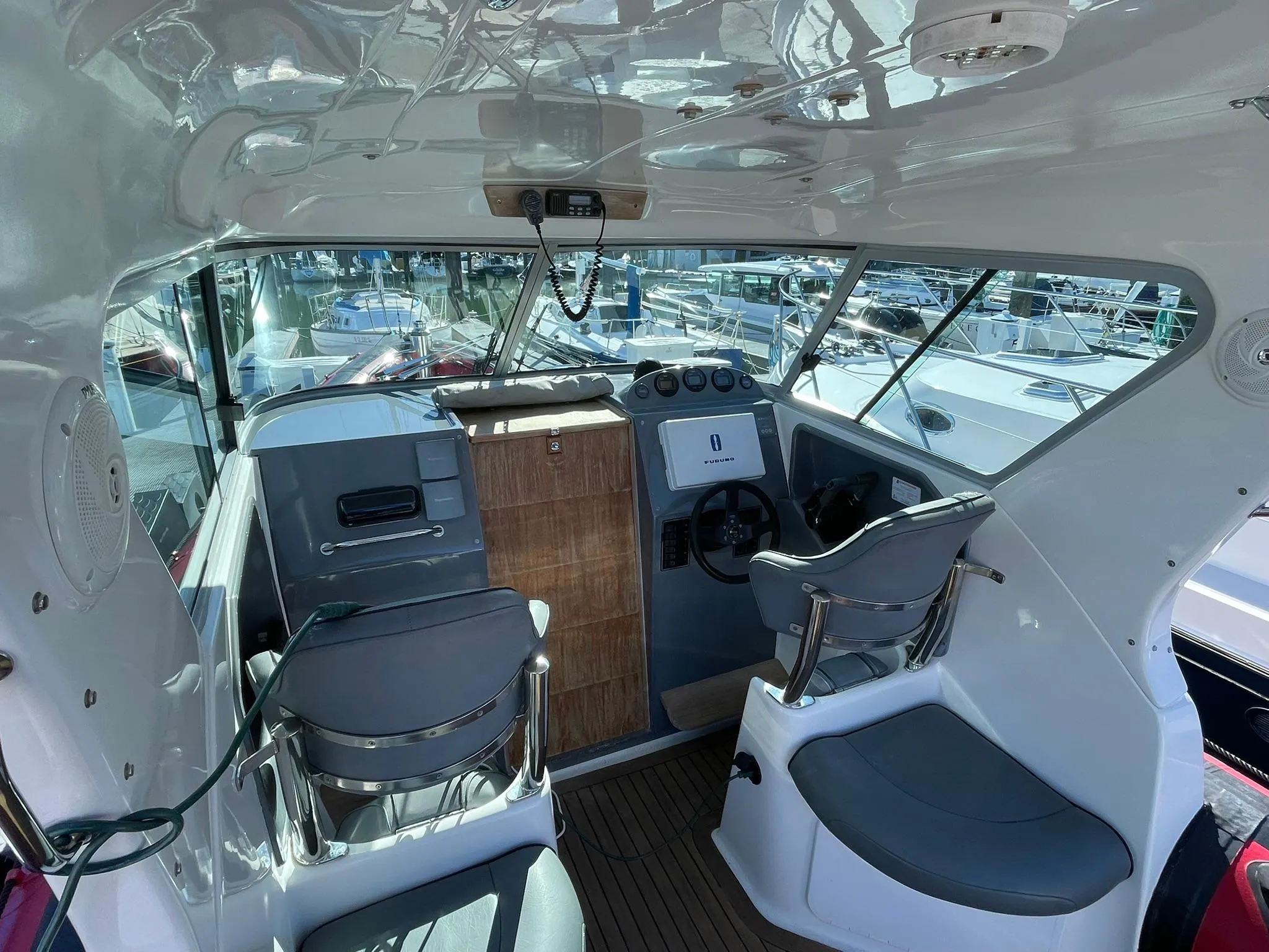 Interior of 2001 Protector Targa 28 boat with helm and seating area.