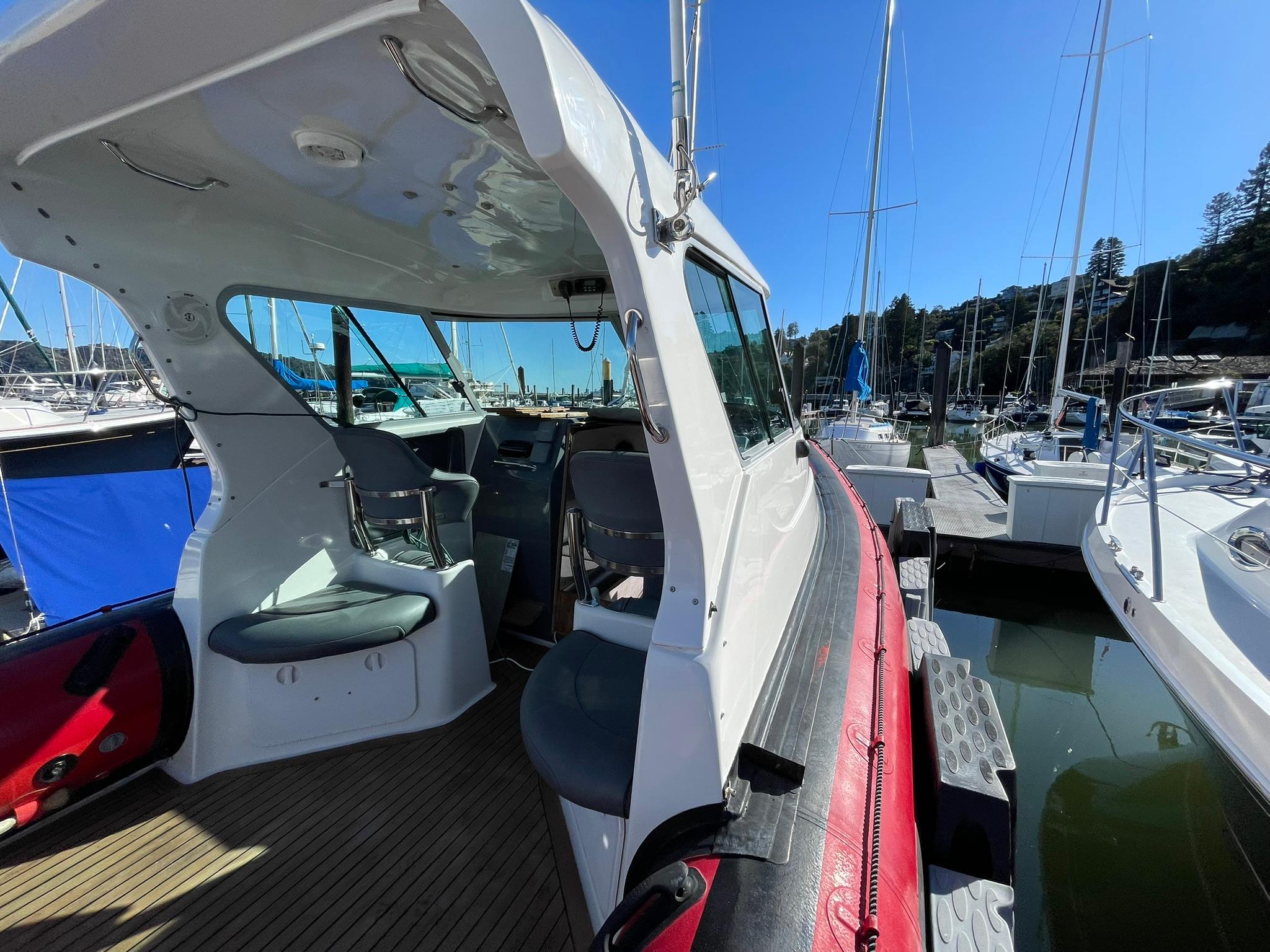 2001 Protector Targa 28 boat interior at marina, showcasing seating and helm area.