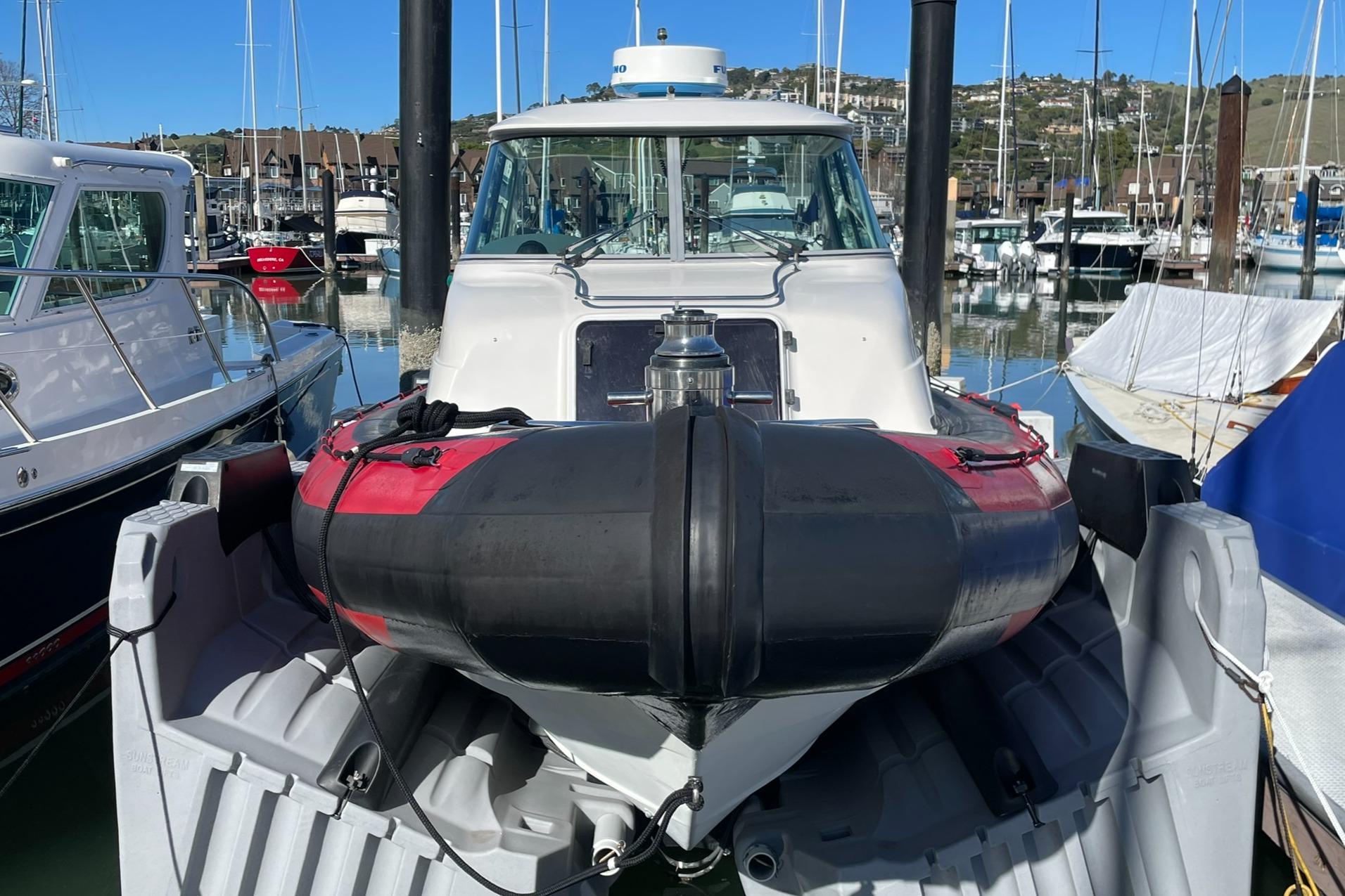 2001 Protector Targa 28 boat docked in a marina, surrounded by other vessels.