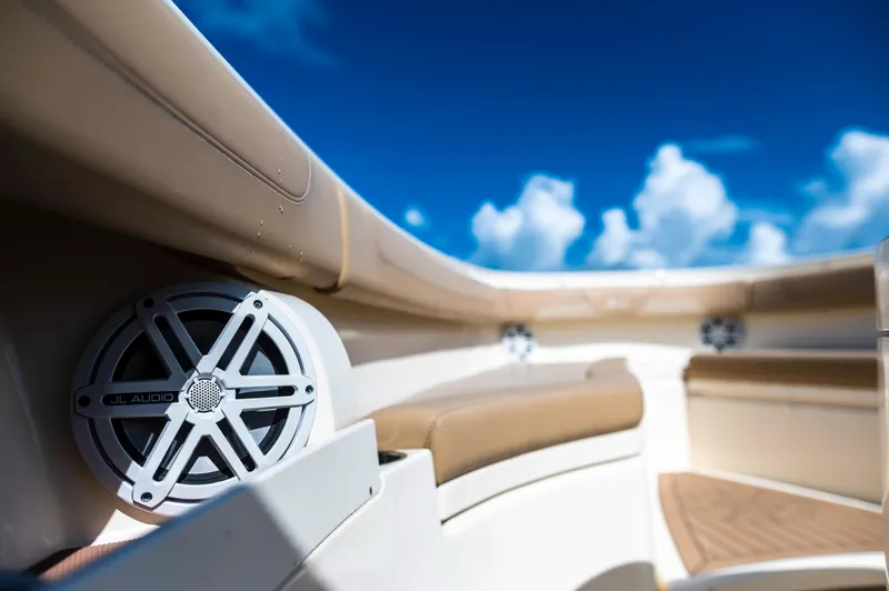  Yacht Photos Pics 2019 Scout 355 LXF boat interior with speakers and cushioned seating under a blue sky.