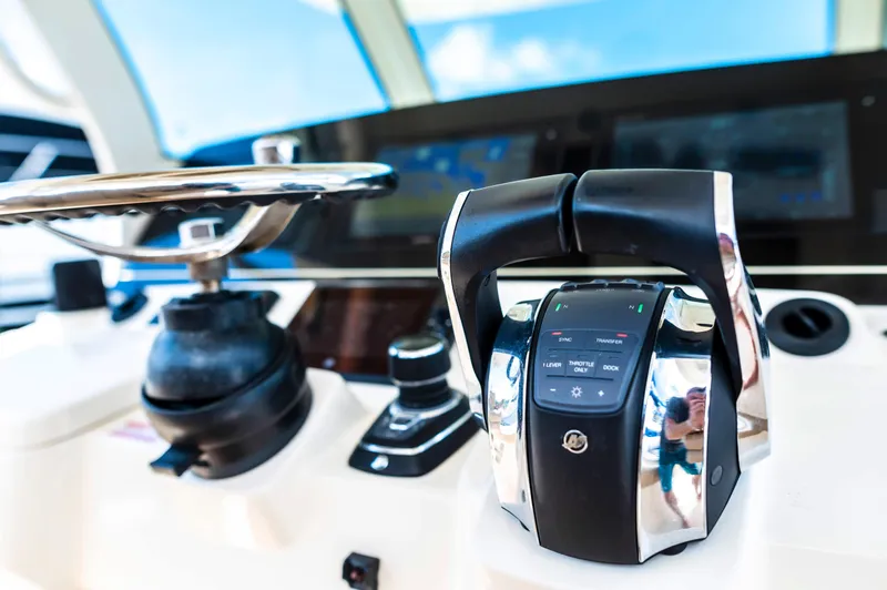  Yacht Photos Pics Control panel of 2019 Scout 355 LXF boat with steering wheel and throttle.