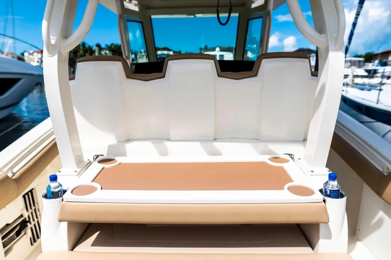  Yacht Photos Pics 2019 Scout 355 LXF boat interior with seating and cup holders, docked at marina.