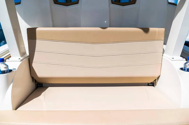  Yacht Photos Pics 2019 Scout 355 LXF boat seat with beige upholstery and sleek design.