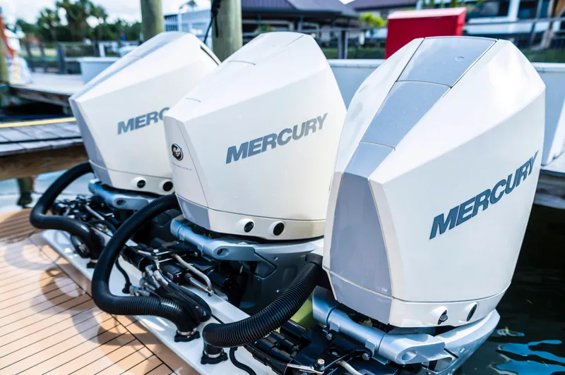 Yacht Photos Pics Triple Mercury outboard engines on a 2019 Scout 355 LXF boat at a dock.