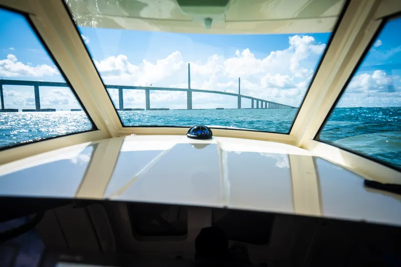  Yacht Photos Pics View from 2019 Scout 355 LXF boat, approaching a bridge over blue ocean waters.