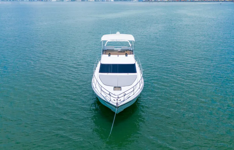  Yacht Photos Pics Azimut 43 Fly yacht from 1998 anchored on calm water, front view.