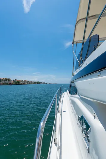  Yacht Photos Pics Azimut 43 Fly yacht cruising on clear blue waters under a sunny sky.