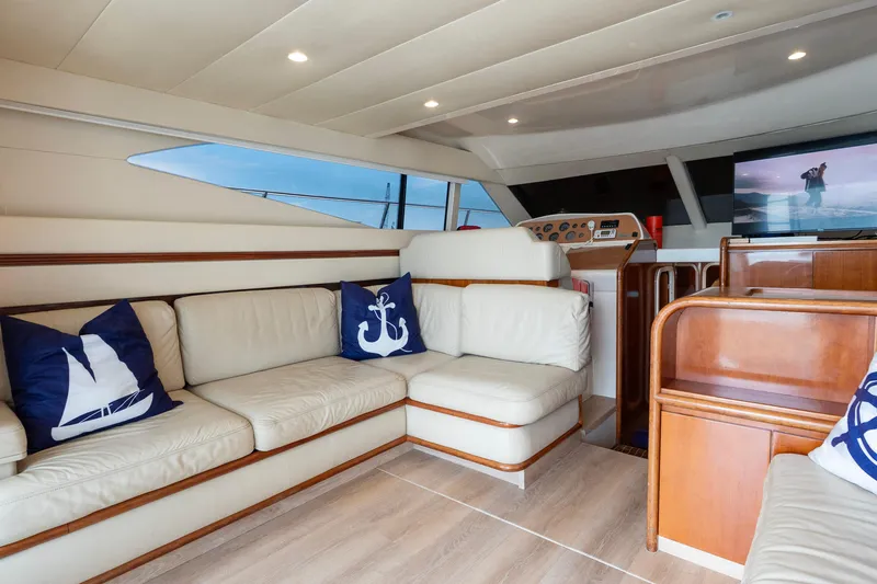  Yacht Photos Pics Luxurious interior of 1998 Azimut 43 Fly yacht with cream leather seating and nautical decor.
