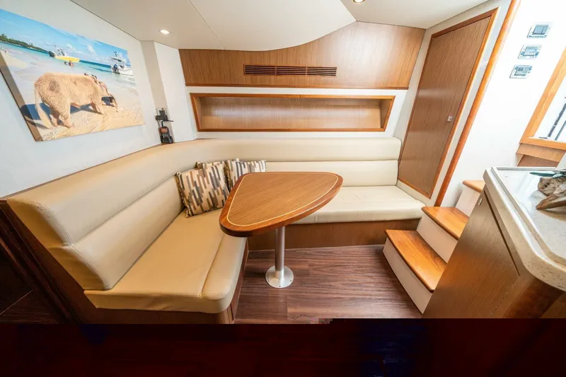 Big Hit Yacht Photos Pics Luxurious interior of 2020 Cabo 40 Express yacht with cozy seating and wooden accents.