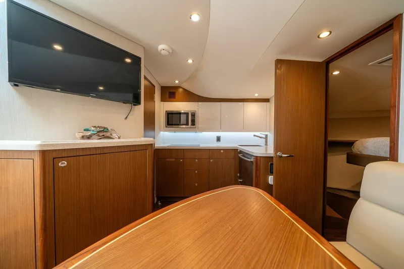 Big Hit Yacht Photos Pics Luxurious interior of 2020 Cabo 40 Express yacht with modern kitchen and TV.