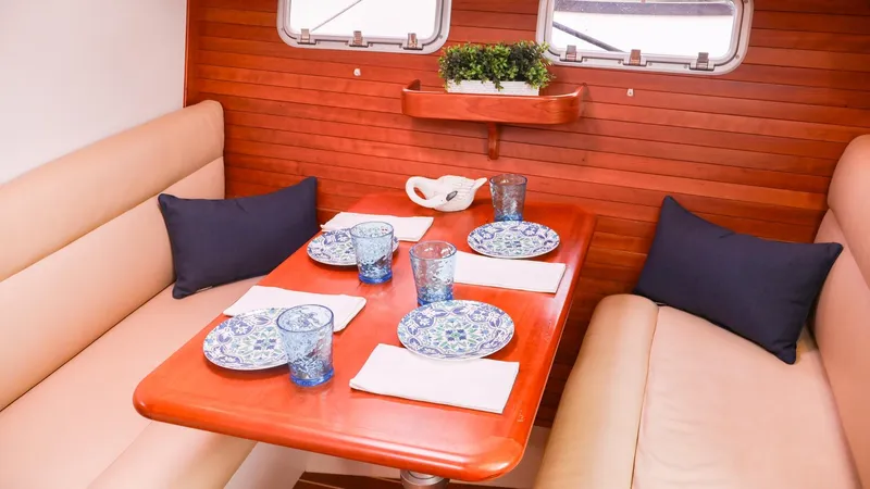 4709tw Yacht Photos Pics Interior dining area of 2010 MJM 40z Downeast yacht with set table.