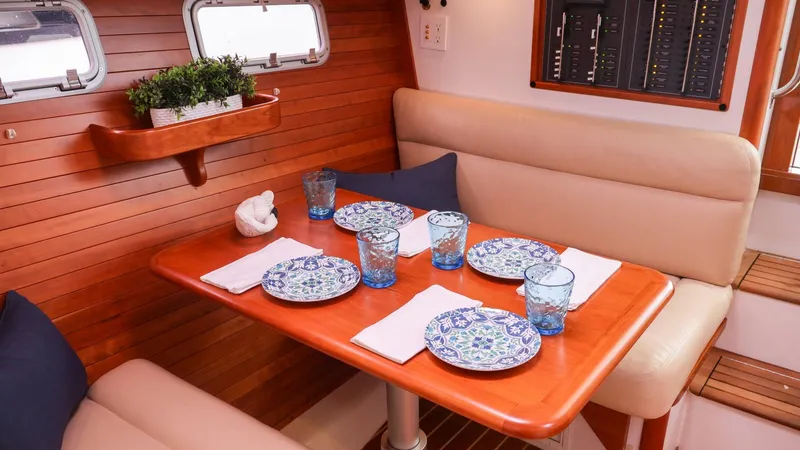 4709tw Yacht Photos Pics Elegant dining area inside a 2010 MJM 40z Downeast boat with wooden table and cushioned seating.