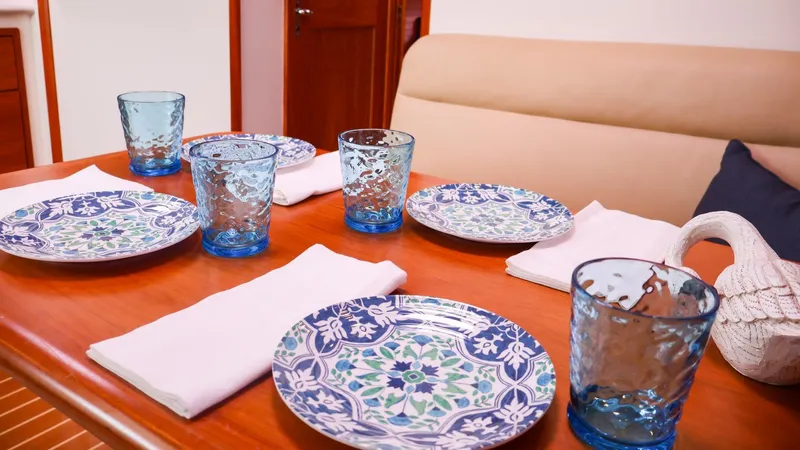 4709tw Yacht Photos Pics Elegant dining setup on a 2010 MJM 40z Downeast boat with blue patterned plates and glasses.