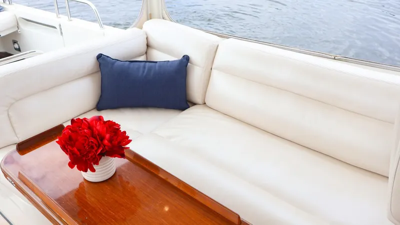 4709tw Yacht Photos Pics Luxurious seating area on 2010 MJM 40z Downeast boat with red flowers and blue pillow.