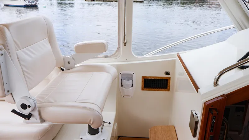 4709tw Yacht Photos Pics Captain's chair on 2010 MJM 40z Downeast boat, overlooking calm waters.