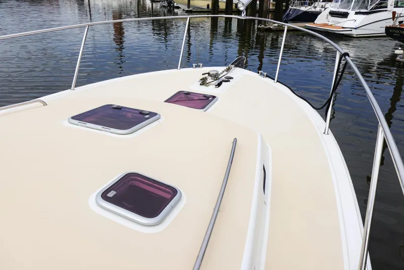 4709tw Yacht Photos Pics 2010 MJM 40z Downeast boat deck with hatches and railing in marina.