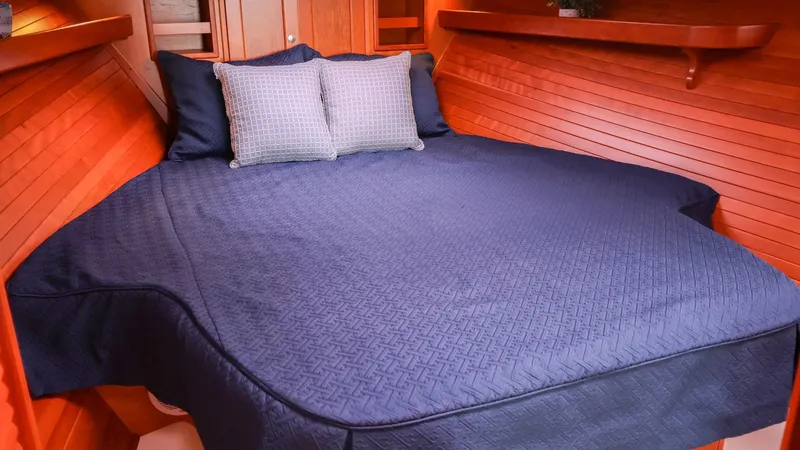 4709tw Yacht Photos Pics 2010 MJM 40z Downeast boat cabin with blue bedding and wooden interior.