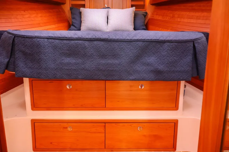 4709tw Yacht Photos Pics 2010 MJM 40z Downeast boat cabin with blue bedding and wooden drawers.