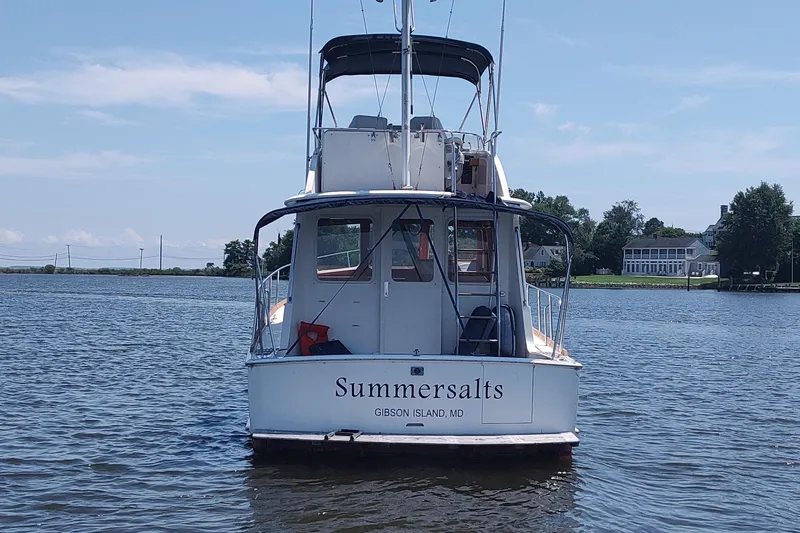 Summersalts Yacht Photos Pics Grand Banks Eastbay 40 Flybridge boat on water, rear view, named "Summersalts," Gibson Island, MD.