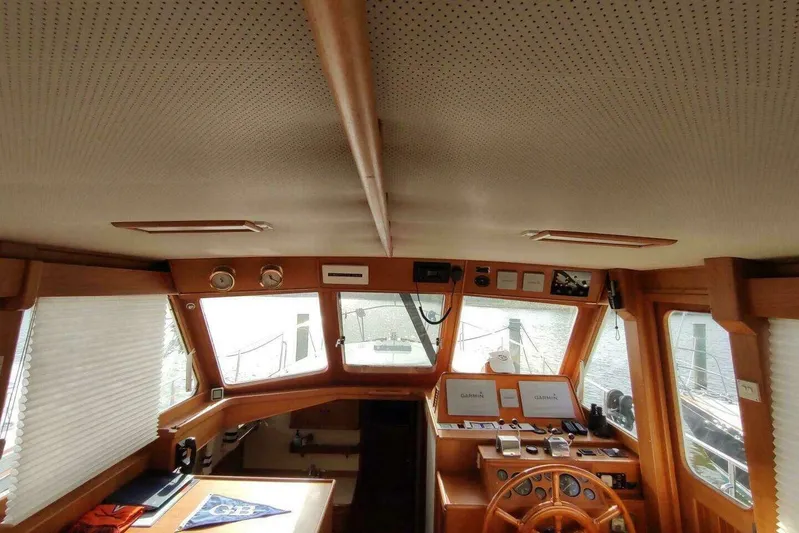 Summersalts Yacht Photos Pics Interior of 1996 Grand Banks Eastbay 40 Flybridge with wooden helm and navigation equipment.