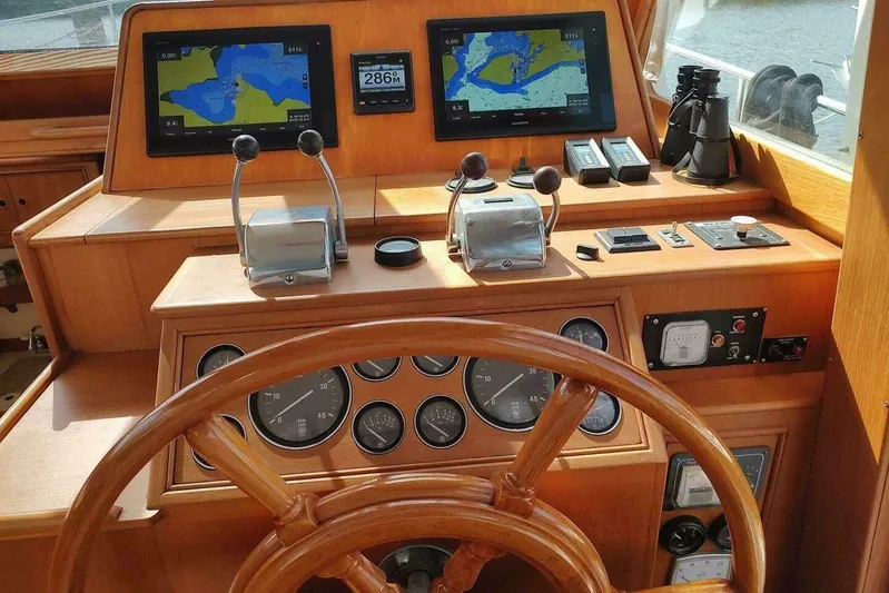 Summersalts Yacht Photos Pics Helm of 1996 Grand Banks Eastbay 40 Flybridge with navigation screens and controls.