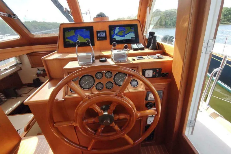 Summersalts Yacht Photos Pics 1996 Grand Banks Eastbay 40 Flybridge helm with wooden wheel and navigation screens.