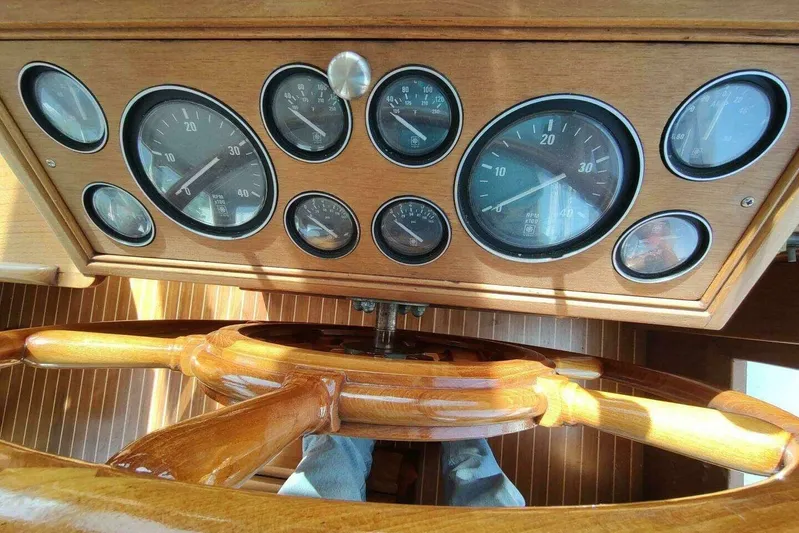 Summersalts Yacht Photos Pics 1996 Grand Banks Eastbay 40 Flybridge dashboard with wooden steering wheel and gauges.