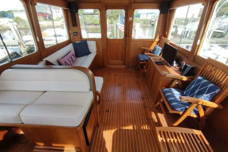 Summersalts Yacht Photos Pics Luxurious 1996 Grand Banks Eastbay 40 Flybridge interior with elegant wood finish and comfortable seating.
