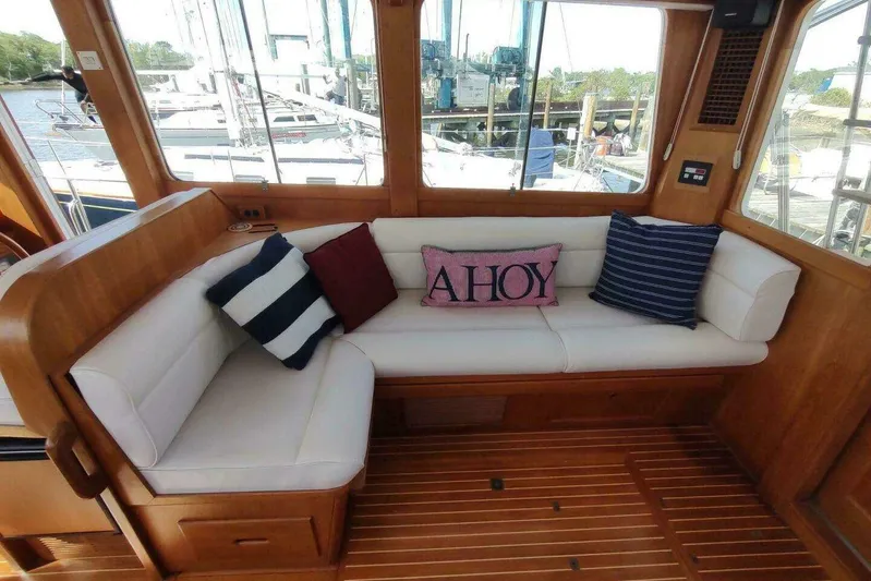 Summersalts Yacht Photos Pics Interior of 1996 Grand Banks Eastbay 40 Flybridge with cozy seating and nautical pillows.