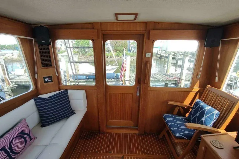Summersalts Yacht Photos Pics Interior of 1996 Grand Banks Eastbay 40 Flybridge with wooden finish and nautical decor.