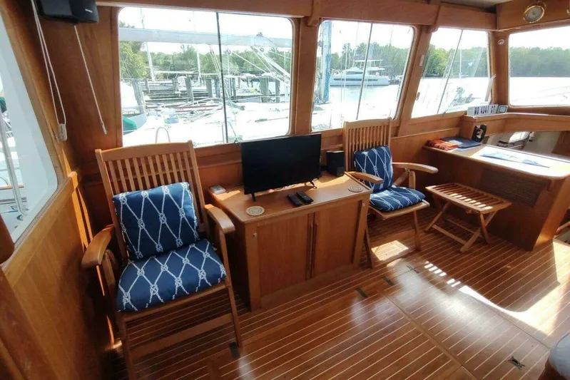 Summersalts Yacht Photos Pics Interior of 1996 Grand Banks Eastbay 40 Flybridge with wooden decor and nautical seating.