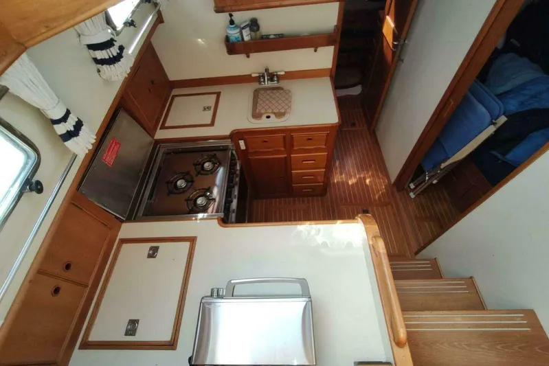 Summersalts Yacht Photos Pics Interior of 1996 Grand Banks Eastbay 40 Flybridge, featuring a compact kitchen area.