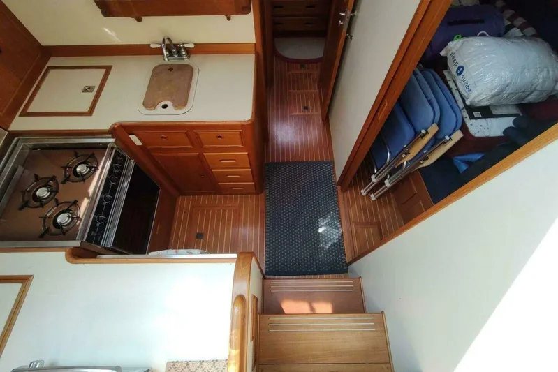 Summersalts Yacht Photos Pics 1996 Grand Banks Eastbay 40 Flybridge interior with kitchen, stove, and storage area.