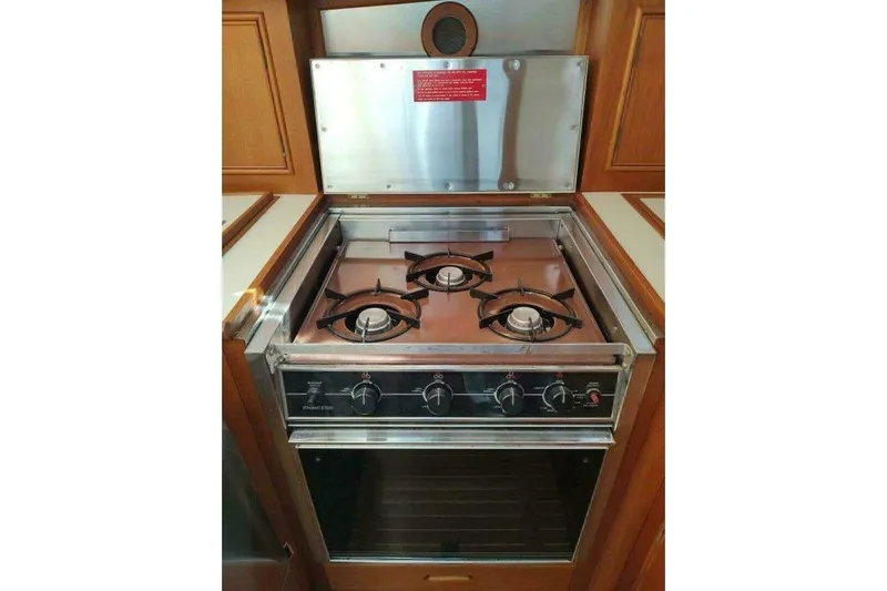 Summersalts Yacht Photos Pics Gas stove and oven in 1996 Grand Banks Eastbay 40 Flybridge yacht kitchen.