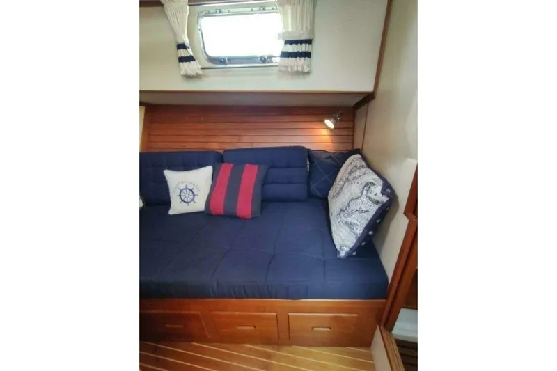 Summersalts Yacht Photos Pics Cozy cabin interior of 1996 Grand Banks Eastbay 40 Flybridge with nautical-themed cushions.