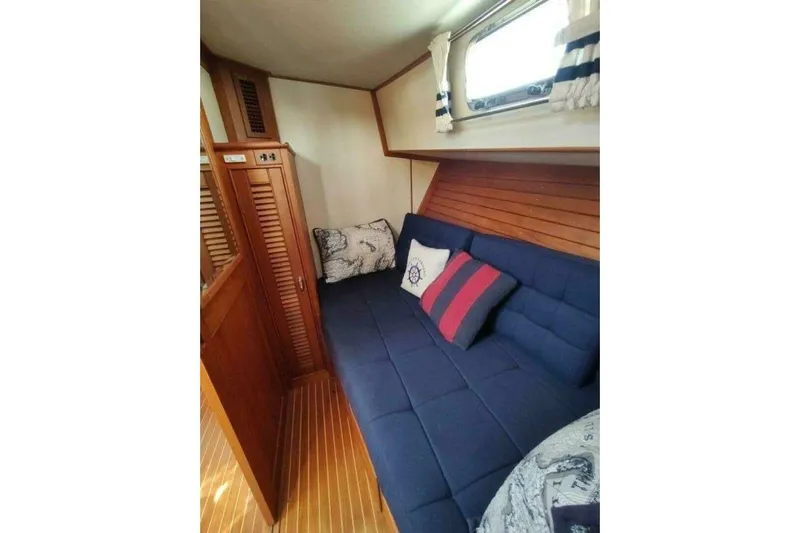Summersalts Yacht Photos Pics Cozy cabin interior of 1996 Grand Banks Eastbay 40 Flybridge with nautical-themed cushions.