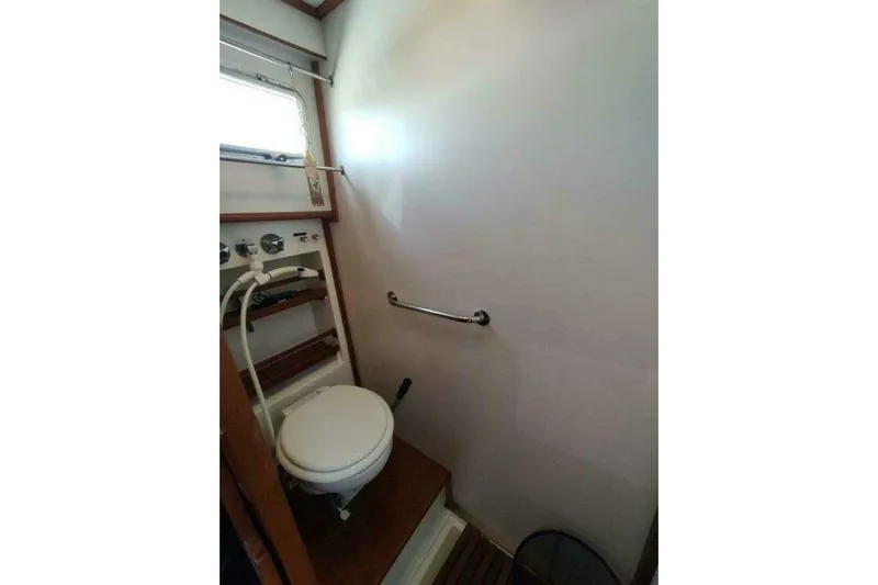 Summersalts Yacht Photos Pics Bathroom interior of 1996 Grand Banks Eastbay 40 Flybridge yacht, featuring a compact toilet.